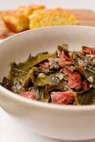 Bowl of Southern Collard Green with bacon, meat, and vinegar.