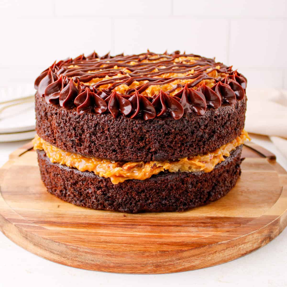 Finished homemade German chocolate cake with coconut pecan filling and ganache border
