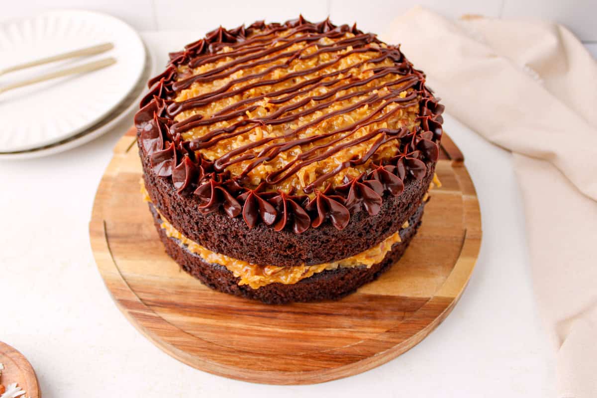 Finished homemade German chocolate cake with coconut pecan filling and ganache border