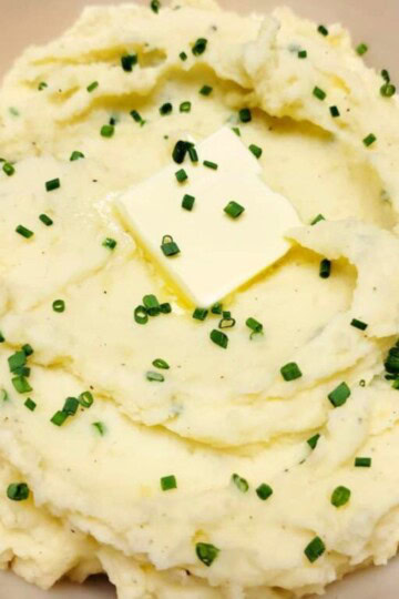 Sour Cream and Chives mashed Potatoes in a white bowl.