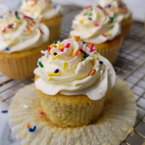 Easy Vanilla Cupcakes with buttercream frosting and rainbow sprinkles.