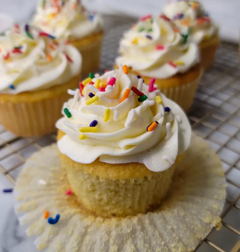 Easy Vanilla Cupcakes with buttercream frosting and rainbow sprinkles.