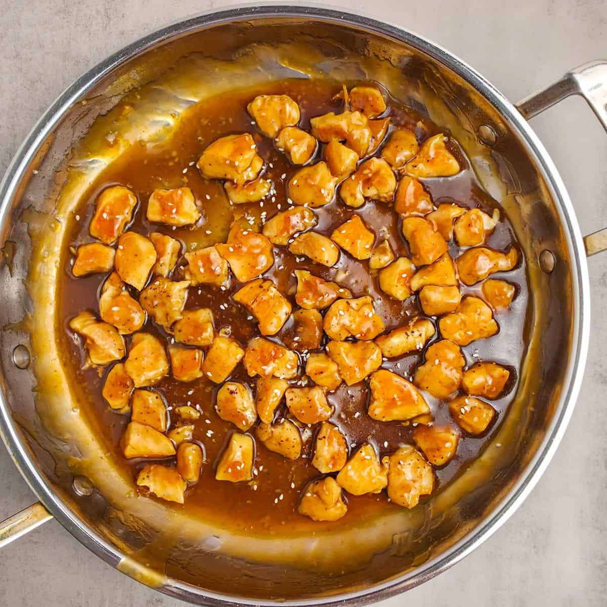 Chicken in pan with teriyaki sauce.