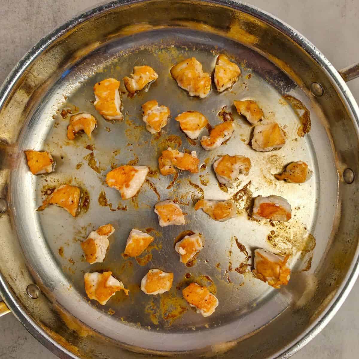 Chicken sauteing in pan for Chicken Teriyaki recipe.