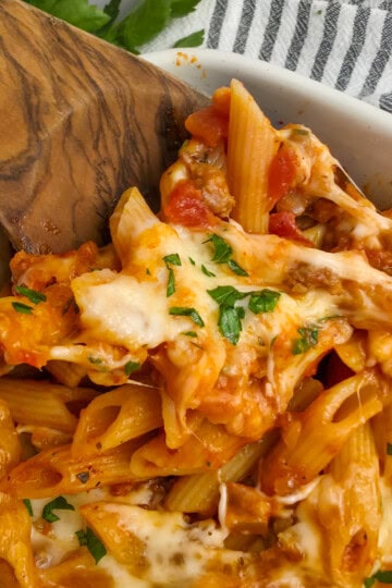 Baked Penne with Sausage with melty mozzarella cheese in a 9x13 baking dish.